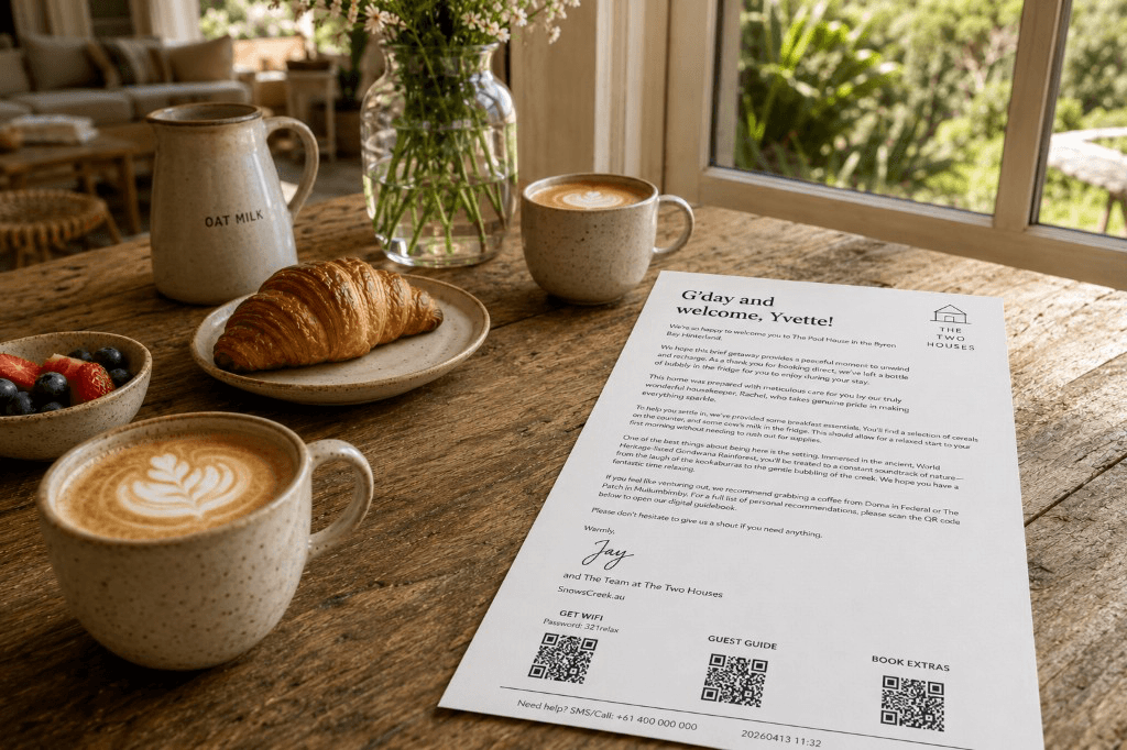 A printed welcome letter on a dining table with flowers and coffee — a thoughtful arrival at a vacation rental.